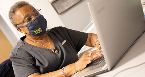 BVMI Volunteer Nurse working on a computer in the BVMI Healthcare Center.