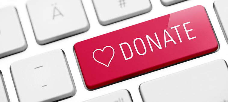 Red Donate Button with a heart on a keyboard.