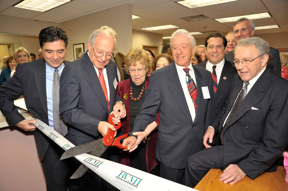 Ribbon cutting ceremony at the opening of the BVMI healthcare clinic. Founder Dr. Sam Cassell featured with numerous guests.