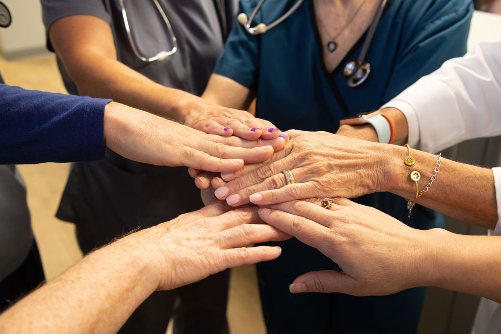 Circle of hands of our nurse volunteers in the clinic.