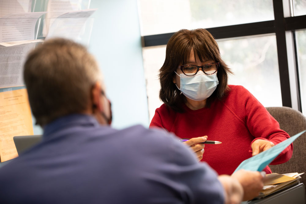 Picture of a male patient meeting with BVMI Case Manager, Rosa.