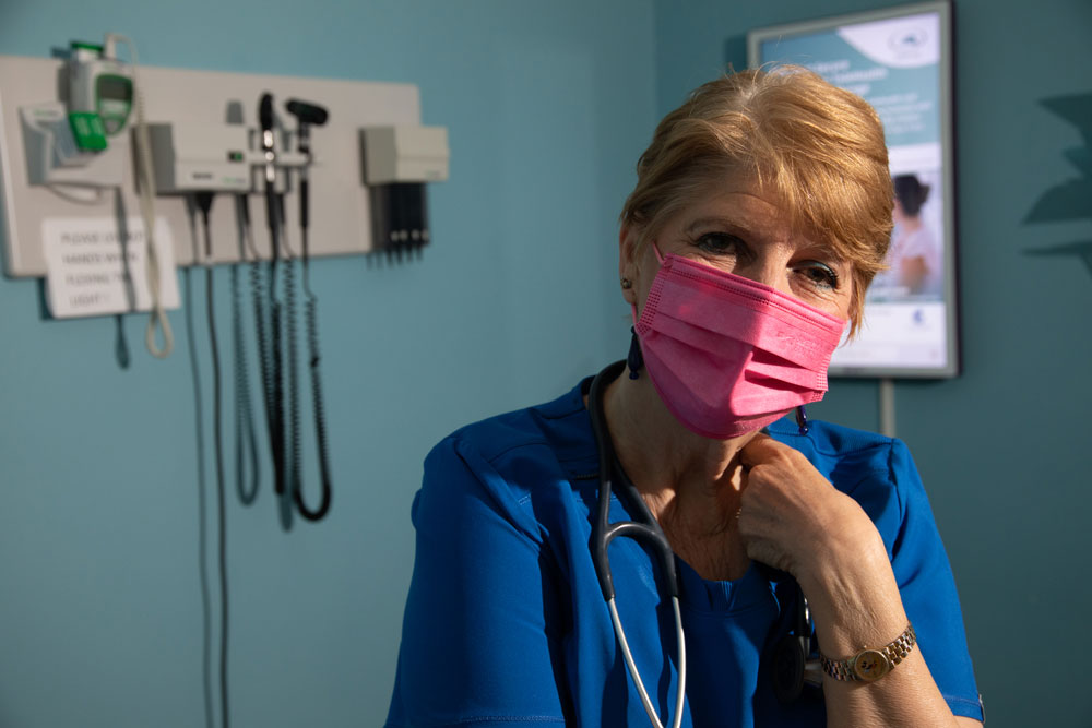 Volunteer Nurse, Victoria - in blue scrubs in the clinic.